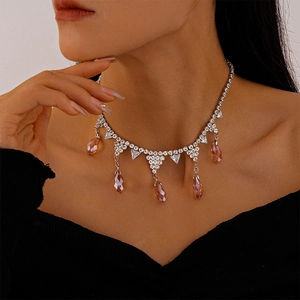 Detail of silver necklace with champagne pink teardrop crystal and pave diamonds on model