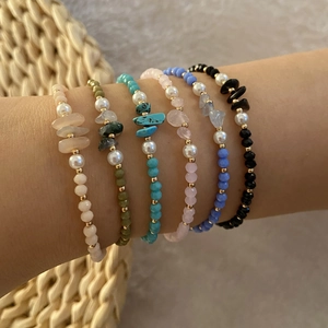 Close-up of Bohemian handmade beaded bracelets with natural stones and faux pearls