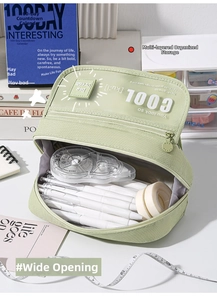 Detail view of large capacity light green pencil case with multiple compartments and wide opening