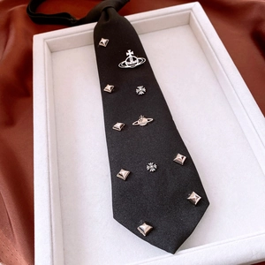 Detail of adjustable black fabric necktie featuring silver planet and cross metal charms