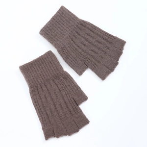 Flat lay of brown cable knit fingerless gloves showing high-quality wool texture