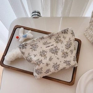 Minimalist cotton floral pouch with blue print and Simple Wish label for cosmetics