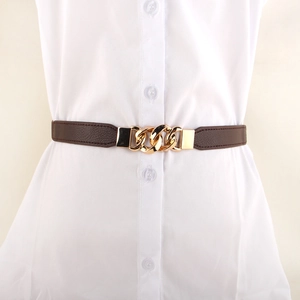 Minimalist dark brown textured elastic waist belt with gold chain buckle on white shirt
