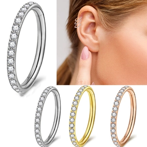 Detail of G23 titanium nose rings in silver, gold, and rose gold with model showcase