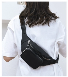 Close-up of black water-resistant nylon waist bag with premium silver metal zippers