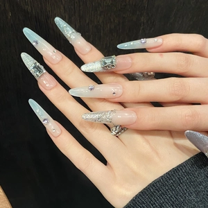 Icy blue gradient stiletto press-on nails with silver glitter and luxury crystals