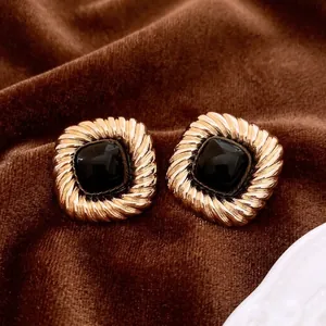 Vintage gold square earrings with twisted texture and black resin inlay on silk