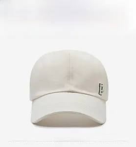 Detail view of a cream-white baseball cap featuring a premium 3D embroidered P letter