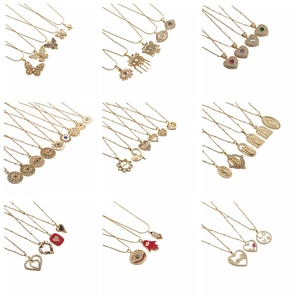 Detailed grid of gold-plated necklaces with assorted pendants like hearts and butterflies