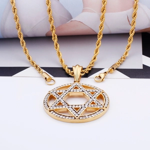 Close-up of a gold hexagonal star pendant with sparkling crystals on a twist rope chain