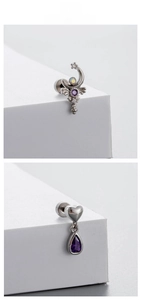 Detail of titanium steel ear studs with purple zircon moon and heart drop pendants