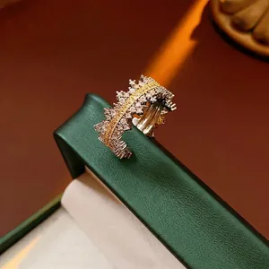 Micro-paved zircon open ring featuring silver metal with yellow crystals on green leather box