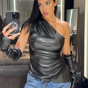 Detail of black PU leather one-shoulder crop top with matching arm sleeves on model