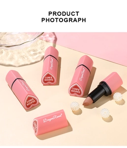 Macro shot of heart-shaped lipstick in matte pink tube and nude velvet texture