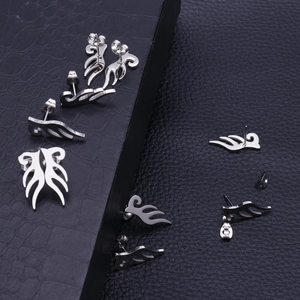 Silver stainless steel angel wing stud earrings displayed on black leather background