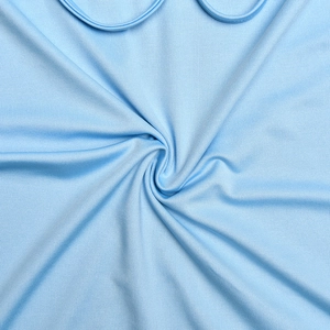 Close-up of light blue ribbed fabric texture and draping detail of the V-neck dress