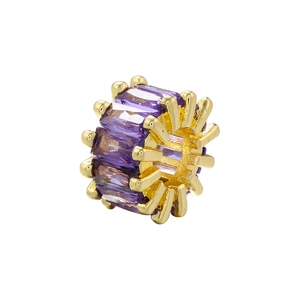 Detailed macro view of an 18K gold-plated barrel bead with inlaid purple crystals for DIY