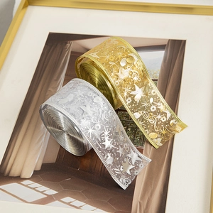 Golden and silver Christmas decorative ribbons with metallic star and music note patterns
