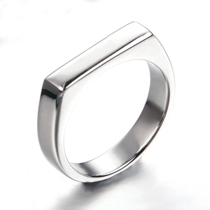 Detailed view of a polished stainless steel signet ring with a rectangular flat top