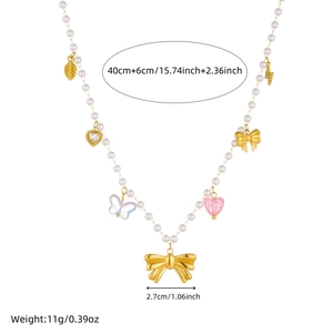 Beaded pearl necklace with gold bow and colorful acrylic butterfly heart charms