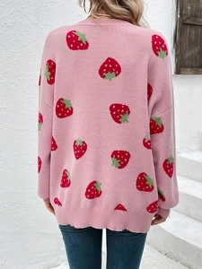Rear view of pink knitted cardigan featuring vibrant red strawberry jacquard patterns