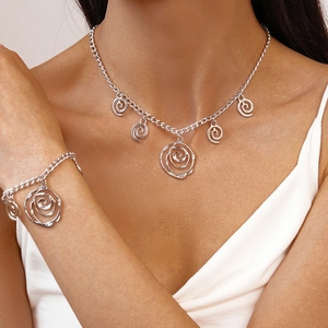 Chic silver hollow rose pendant necklace and bracelet jewelry set on model