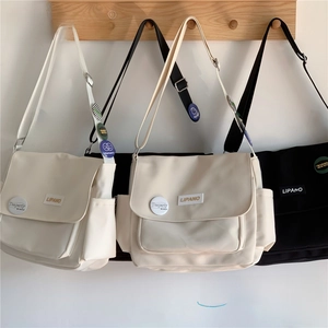 Detail of durable canvas messenger bags with flap closures and side storage pockets