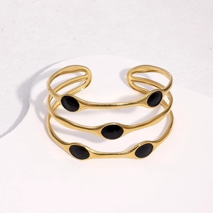 Three-piece set of 18k gold-plated open bangles with elegant black enamel oval accents