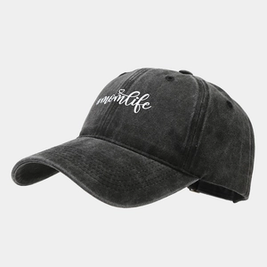 Macro detail of washed grey baseball cap with white #momlife heart embroidery texture