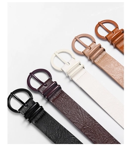 Detail view of five assorted faux leather belts with matching circular resin buckles