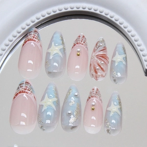 Blue ocean-themed almond press-on nails with 3D starfish, pearls, and glitter on mirror
