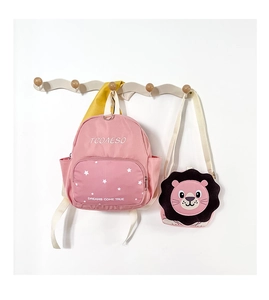 Pink kids backpack with white star pattern and detachable lion crossbody bag hanging
