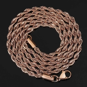 Close-up of polished rose gold rope chain with lobster clasp on reflective black surface