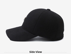 Detail view of black wool baseball cap with fleece lining and metal emblem on the side