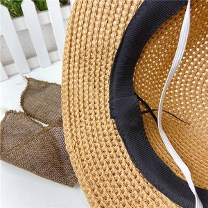Detail of hand-woven straw hat showing interior sweatband and adjustable drawstring