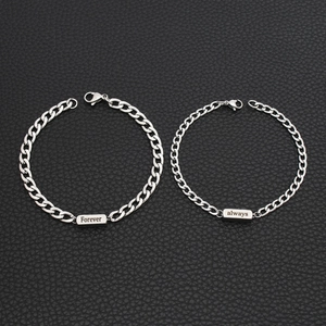 Detail of silver couple bracelets with Forever Always engraving on polished curb chains