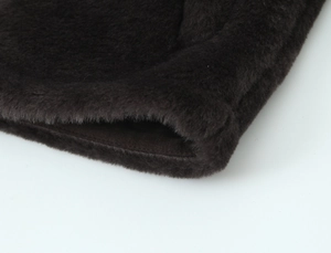 Detailed macro view showing the plush texture and stitching of this brown faux fur jacket