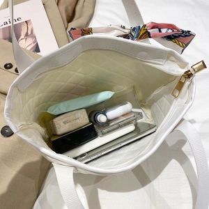 Quilted white tote bag with silk scarf showing large capacity for cosmetics and daily items