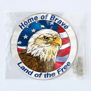 Detail of round acrylic pendant with American flag eagle and Home of Brave text in packaging