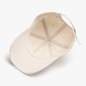 Off-white washed cotton baseball cap with distressed hole details and soft top style