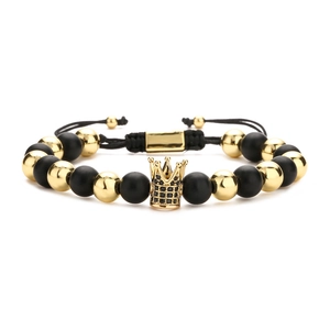 Men's adjustable braided bracelet featuring matte black beads and a gold micro-pave crown