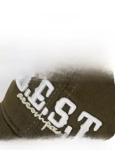 Close-up of olive green baseball cap featuring white 3D boucle embroidery with BEST letters