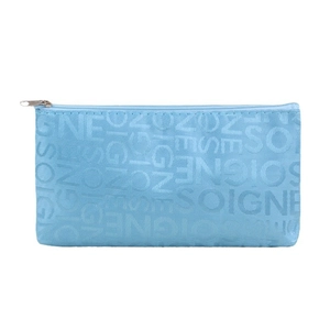 Blue rectangular fabric makeup bag with SOIGNE jacquard lettering and top zipper
