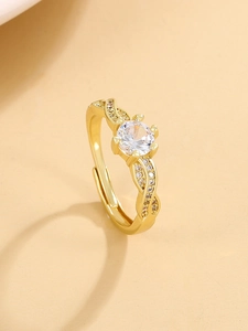 Macro shot of crown ring showing intertwined hollow band and pavé set cubic zirconia