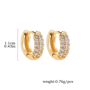 Detail view of gold hoop earrings with white zircon showing dimensions 1.1cm and 0.76g weight