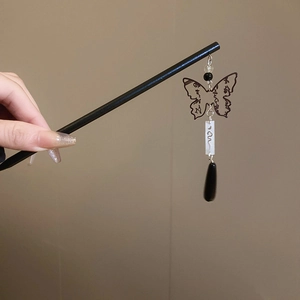 Detail of a Chinese hair stick with butterfly pendant and black teardrop tassel