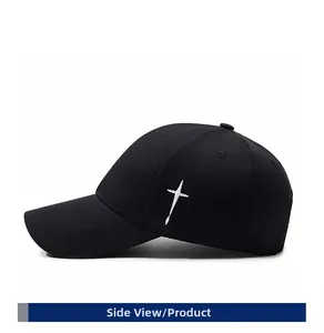 Side view detail of black twill cotton baseball cap with white cross embroidery