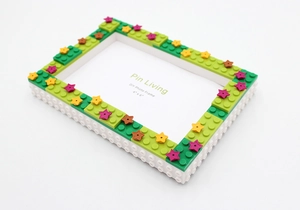 Detail of 4x6 DIY building block photo frame in green and white with star accents