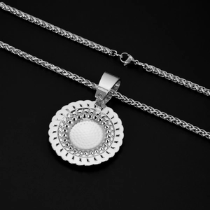 Detail of silver round medallion necklace with textured center and studded edge detailing