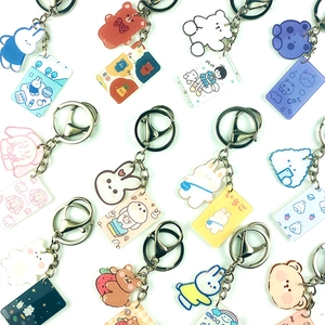 Cute acrylic cartoon bear and rabbit keychains with double metal clasps on white background